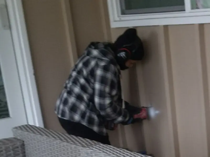 Professional electrician installing an exterior outlet in Milan