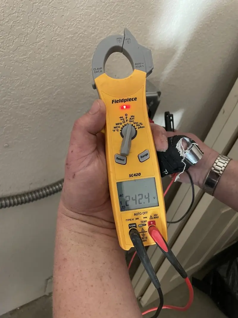 Voltage testing with clamp meter during Electrical Installation Services in Milan